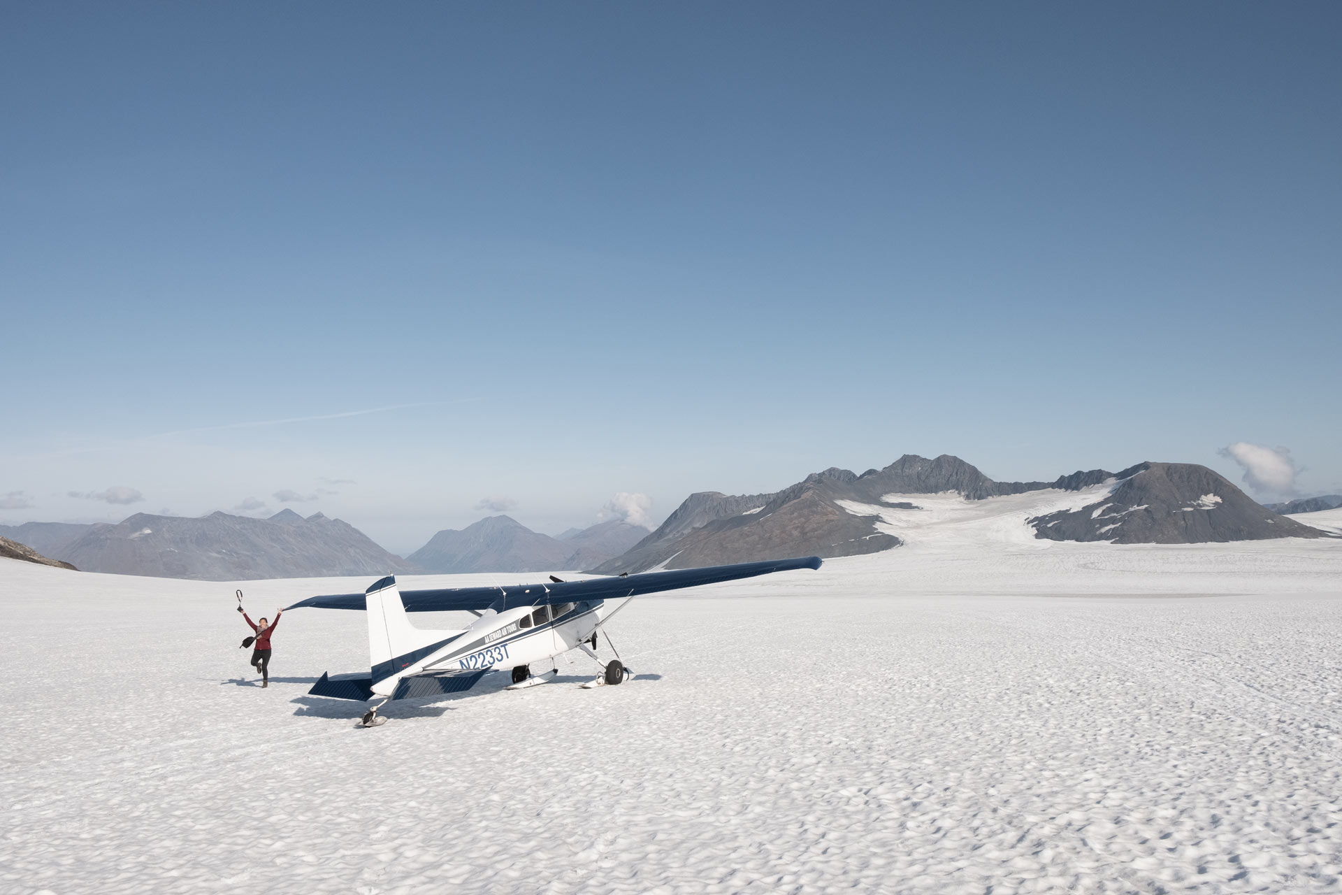 Small plane on a glacier with mountains — Enki Tech